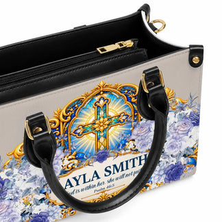 Custom handbag featuring a decorative gold cross, elegant blue floral patterns, and personalized text for a gift.