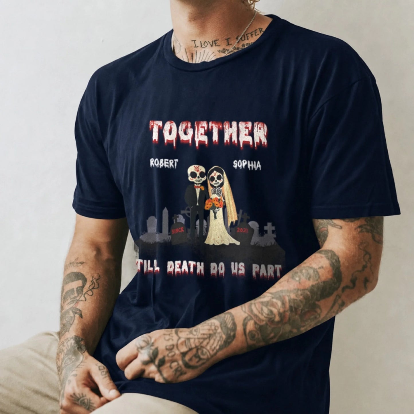 A navy blue personalized tshirt featuring a skeleton bride and groom, custom names Robert and Sophia, and the quote together till death do us part.