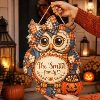 A decorative Halloween owl wooden sign personalized for The Smith family with a pumpkin candy bucket, perfect for decor.