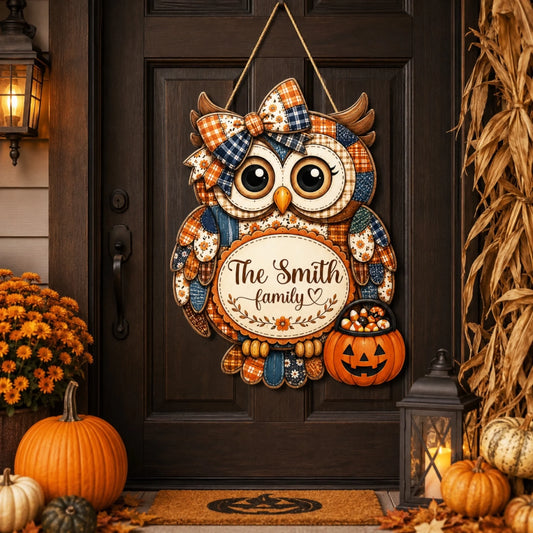 A rustic wooden owl door hanger featuring a personalized The Smith family sign and a candy corn pumpkin for Halloween decor.