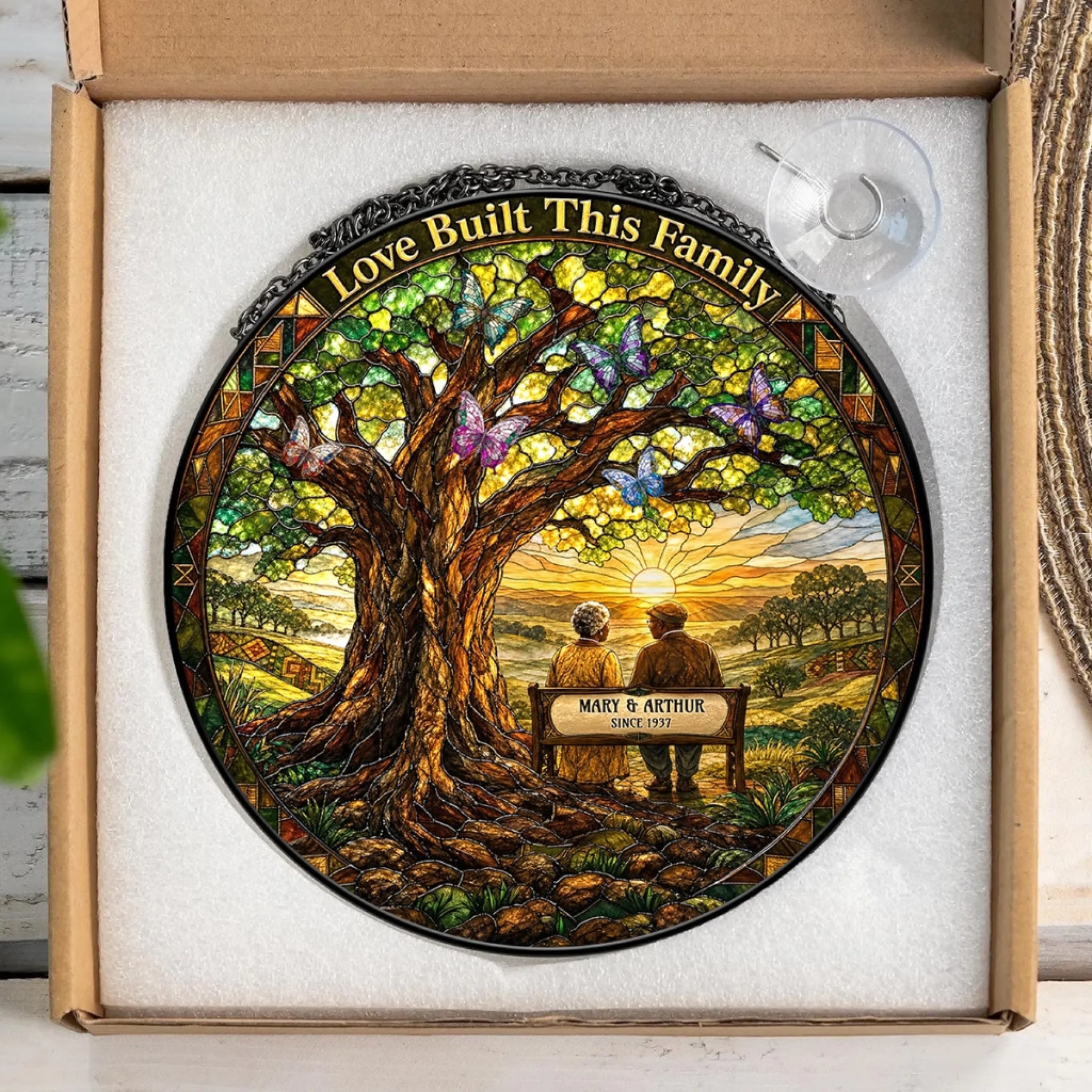 Custom stained glass suncatcher gift in box, personalized with names and date for an anniversary or memorial.