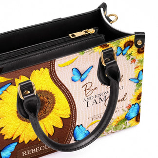 Personalized PU leather handbag featuring sunflower and butterfly artwork with custom name and Psalm 46 10 Bible verse.