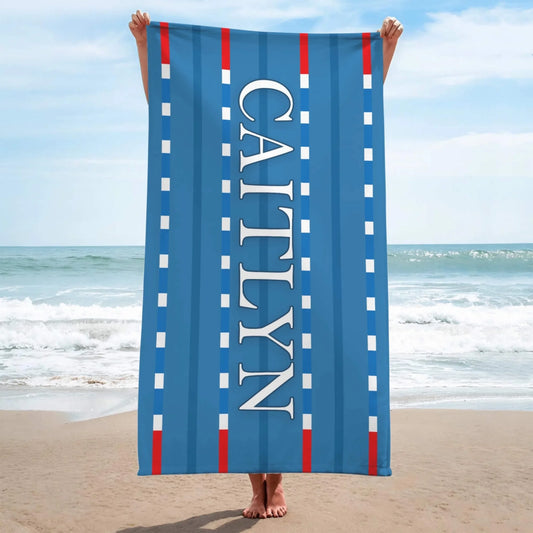 Custom swimming lane beach towel featuring a blue pool lane design with the personalized name Caitlyn printed on it.