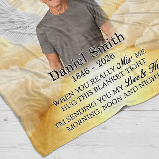 Close up of a personalized memorial blanket with the name Daniel Smith and custom dates printed on soft fabric.