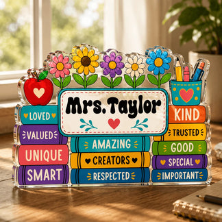 Acrylic teacher desk sign featuring books, flowers, an apple, and the custom name Mrs. Taylor.