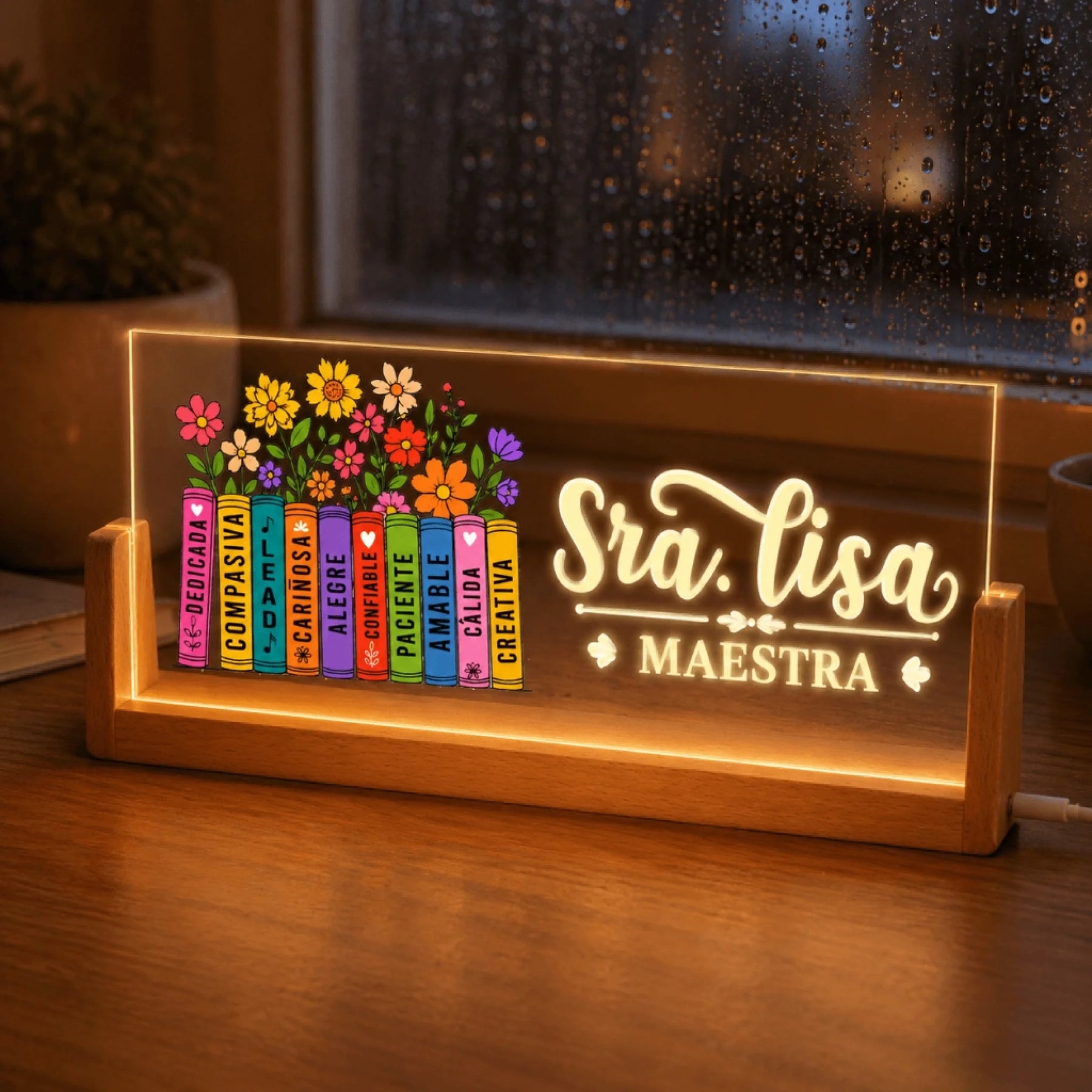 Custom Sra Lisa teacher gift LED night light with floral books design shown against a rainy window background