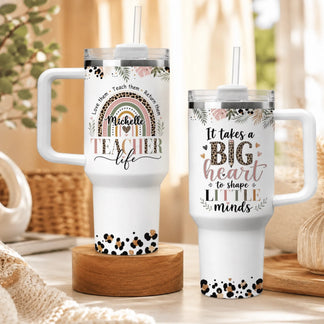 Set of two personalized teacher tumblers featuring rainbow designs and big heart quotes, ideal for teacher appreciation.
