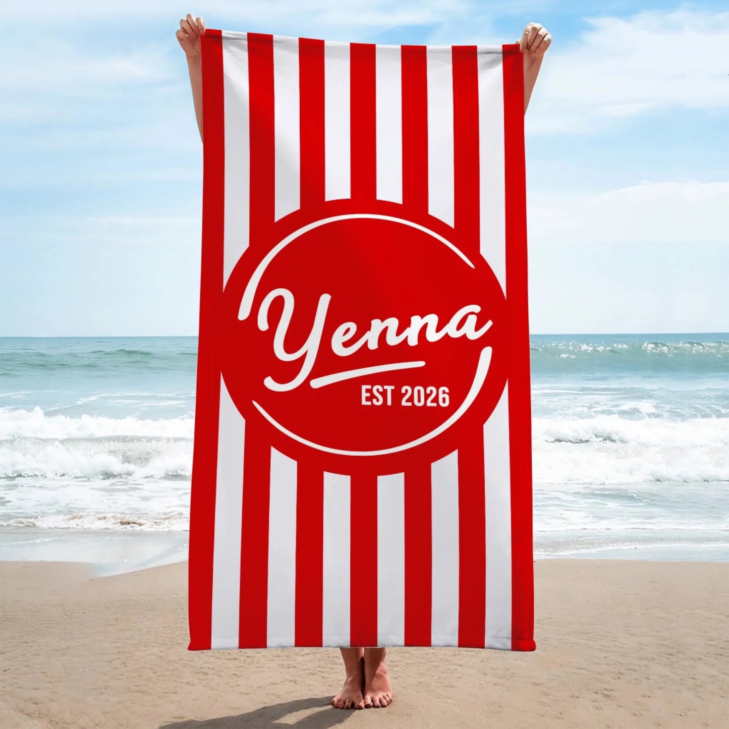 Custom beach towel with bold red and white vertical stripes and a center medallion personalized with a name and date.