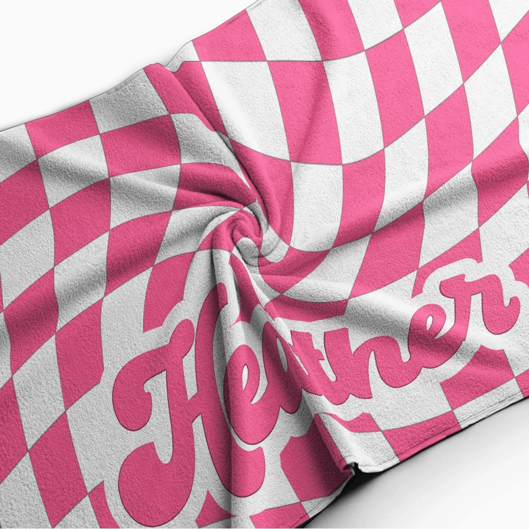 Close up of a personalized beach towel with a groovy pink and white distorted checkerboard pattern and custom name.