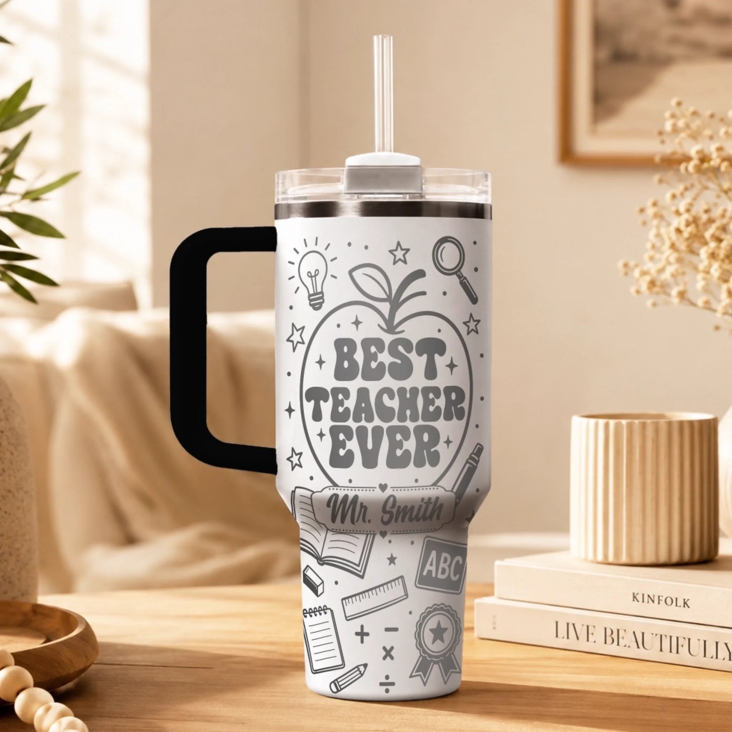 White personalized stainless steel tumbler with best teacher ever quote and school supply patterns for school.