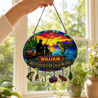 Decorative stained glass panel with fishing design and text, held in front of a window.