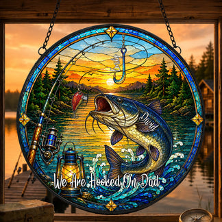 Stained glass artwork with a fish, fishing rod, and sunset over water scene.