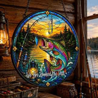 Stained glass panel with fishing scene and text 'We Are Hooked On Dad' in a rustic setting.