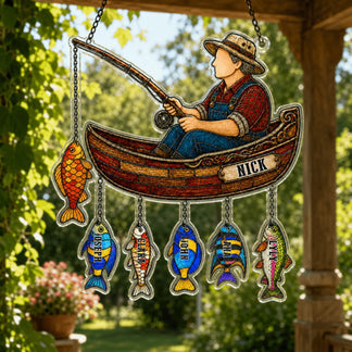 Decorative hanging sign with a fisherman in a boat and colorful fish, set against a natural outdoor background.