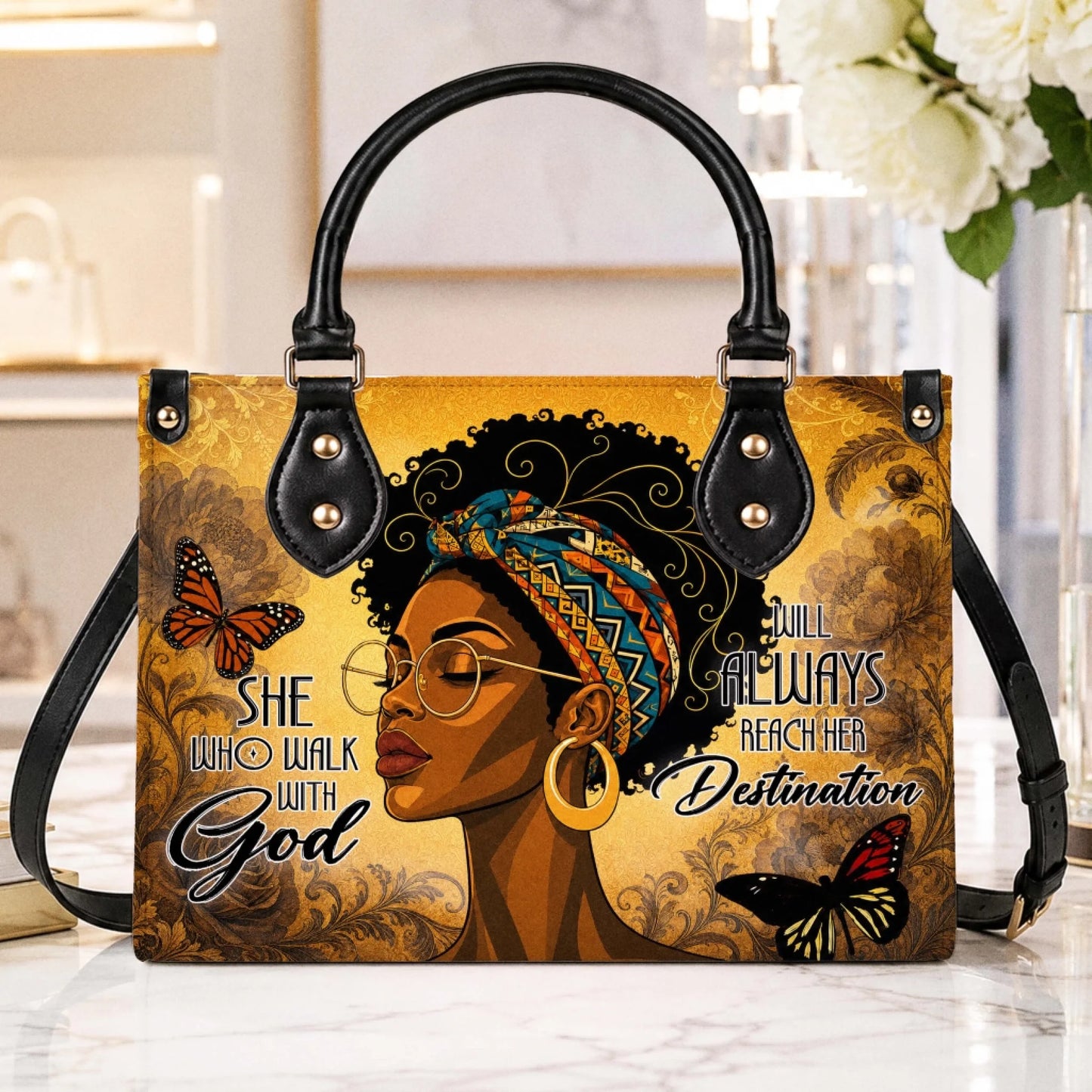 Artistic handbag display featuring a Black woman with a headwrap and inspirational faith-based message and butterfly art.