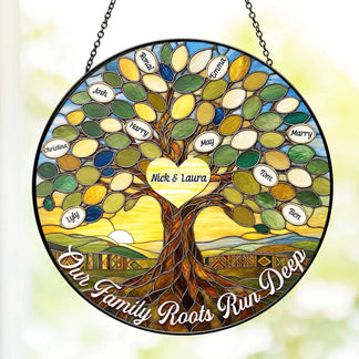 Round stained glass suncatcher with a tree of life theme, customized with names and hanging by a chain against a soft outdoor background.