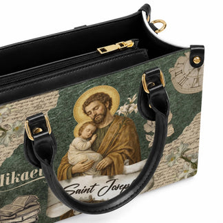 Close up of a religious themed handbag featuring Saint Joseph holding the baby Jesus on a textured green background.