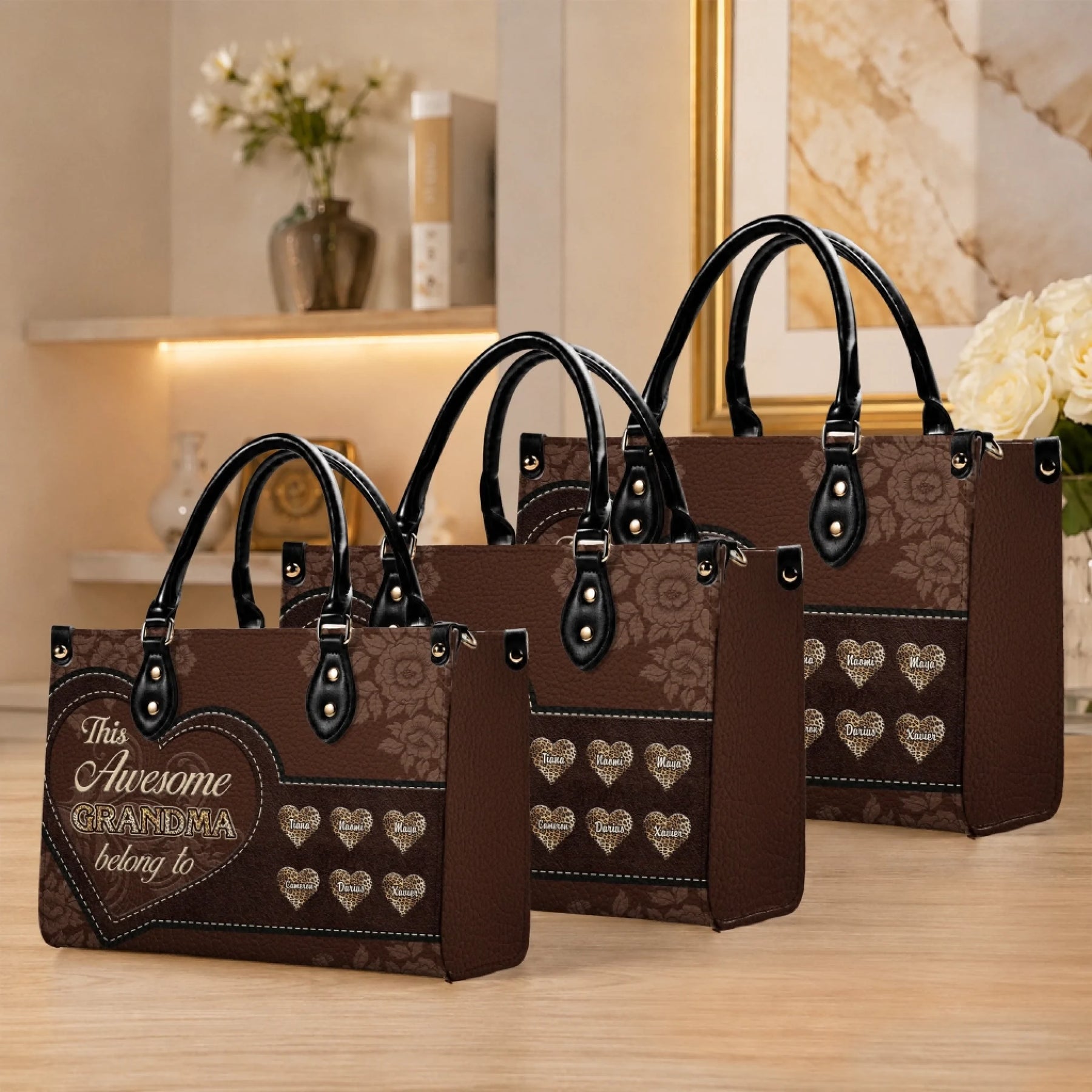 Three different sizes of personalized grandma handbags featuring elegant floral designs and custom name hearts.
