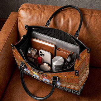 Interior view of a personalized Sistas Forever handbag filled with a laptop, journal, phone, and daily accessories.