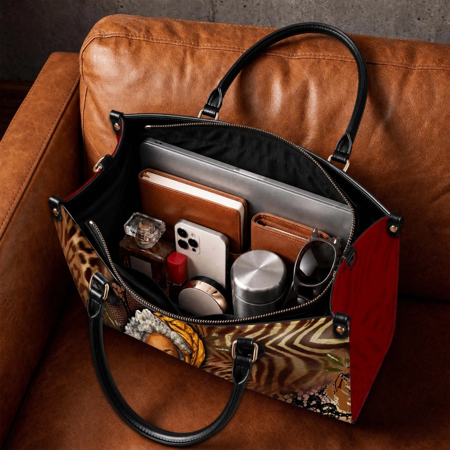 Spacious interior of a Black Mom Magic tote bag organized with a laptop book phone and personal accessories