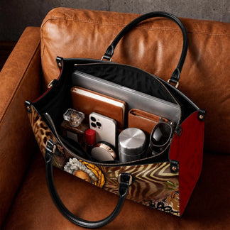 Spacious interior of a Black Mom Magic tote bag organized with a laptop book phone and personal accessories