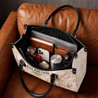 Spacious interior of a personalized Mother Mary angel handbag organized with a laptop notebook phone and everyday items.