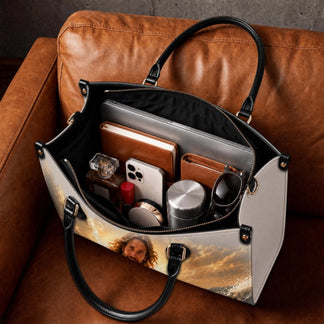 Interior view of a spacious religious themed PU leather handbag packed with everyday essentials and accessories.
