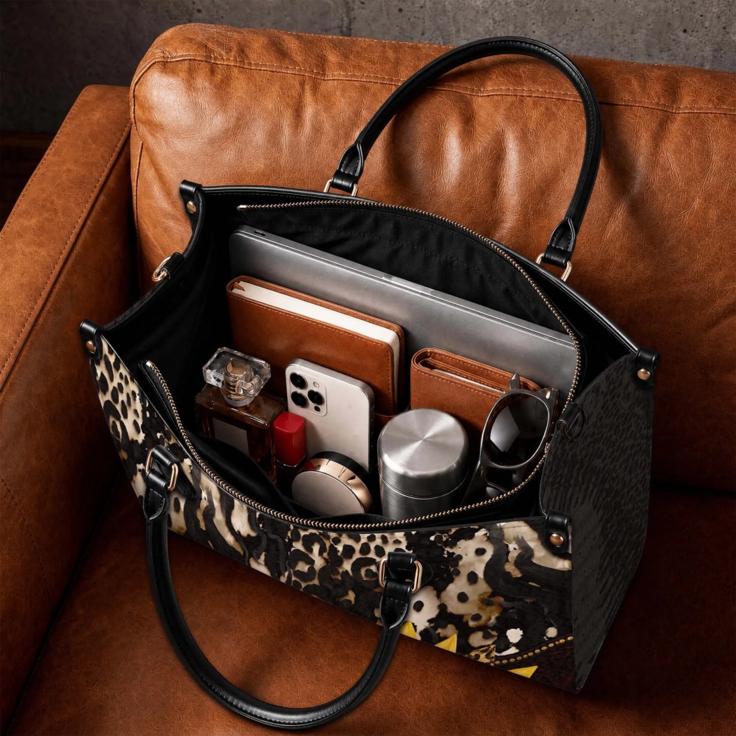 The spacious interior of a personalized sunflower handbag filled with daily essentials like a laptop, phone, and wallet.