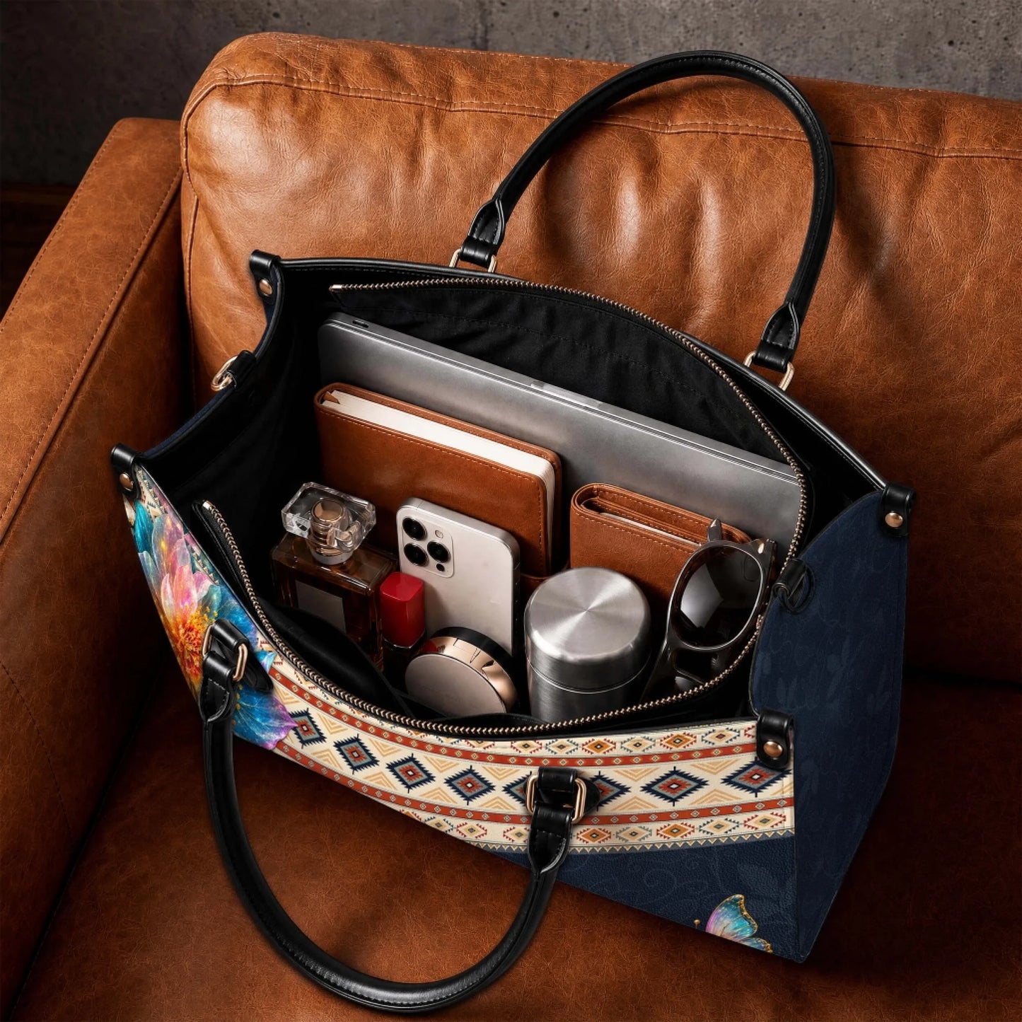 Interior view of personalized handbag filled with daily essentials including laptop notebook and personal items