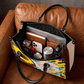 Spacious interior of a sunflower and butterfly print tote bag organized with a laptop book phone and daily essentials.