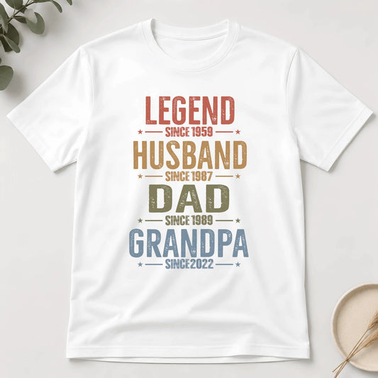 White t-shirt with colorful text design on a light gray background