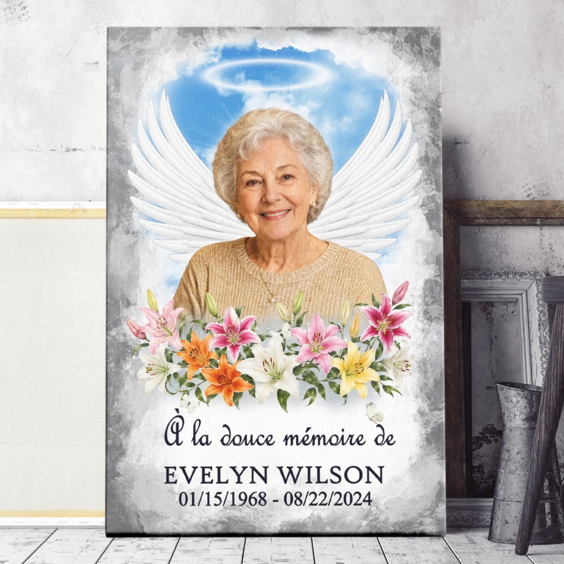 Toile personnalisée avec photo, ailes d'ange et lys colorés pour commémorer la vie d'un proche.