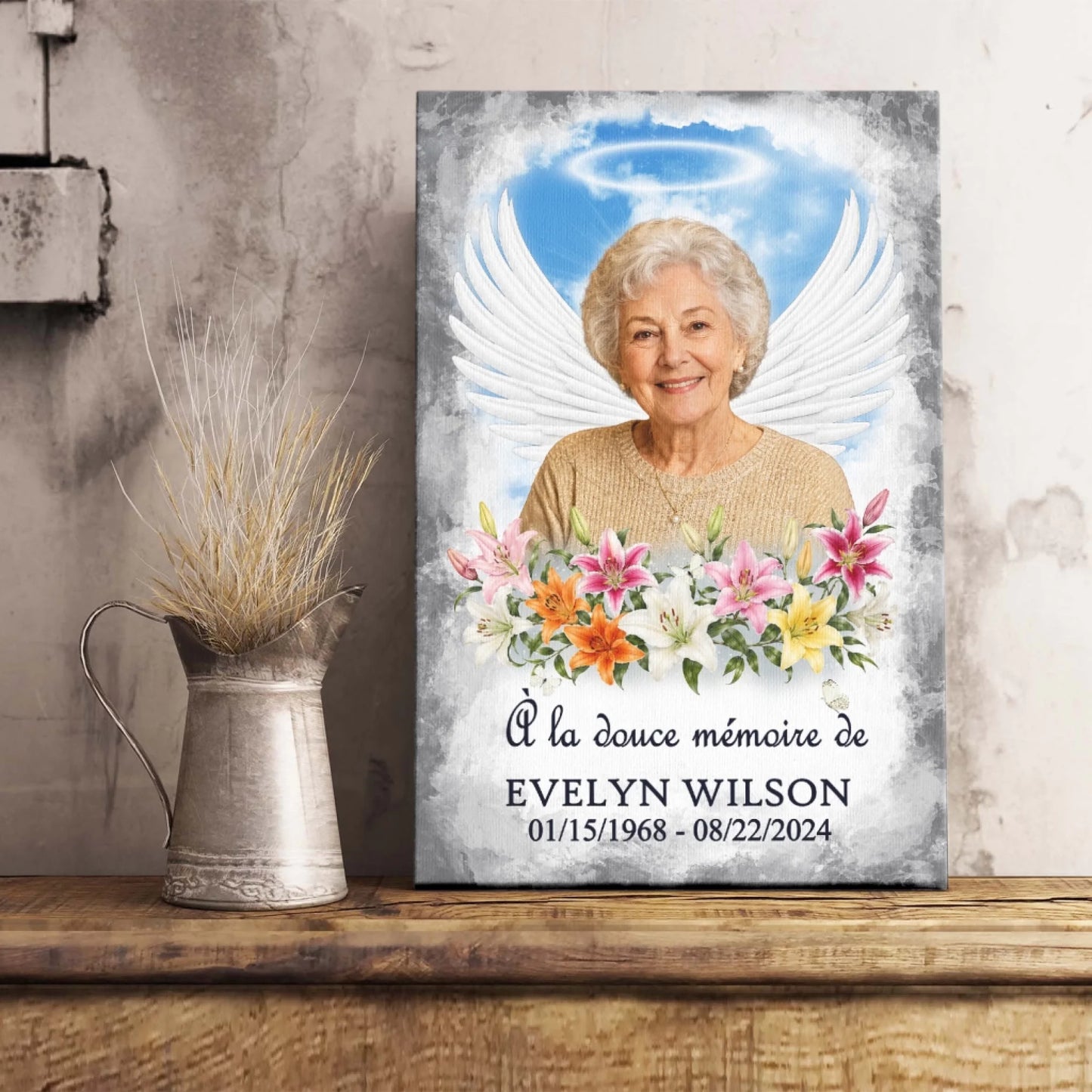 Tableau souvenir avec portrait photo, ailes d'ange et lys, idéal comme cadeau de condoléances.
