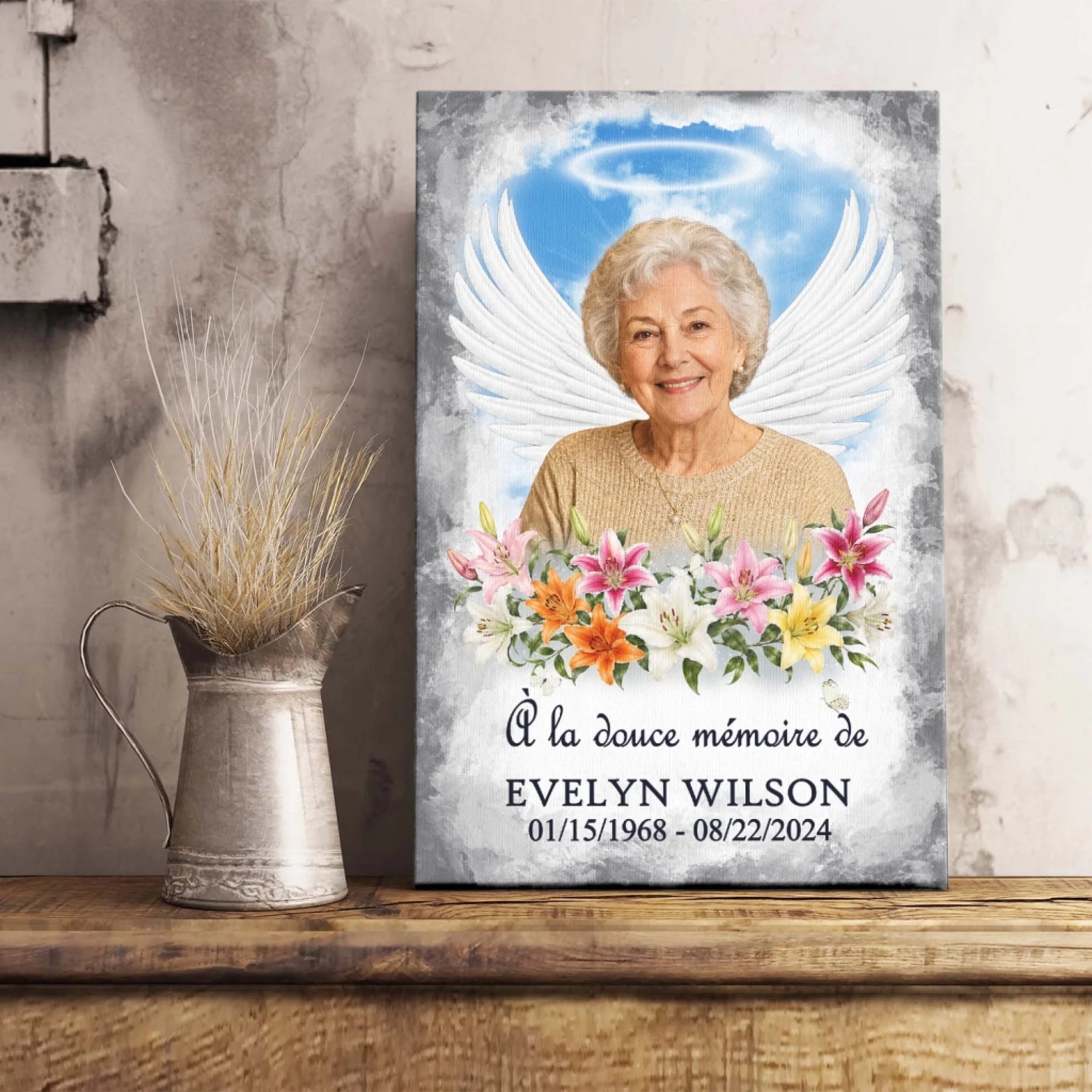 Tableau souvenir avec portrait photo, ailes d'ange et lys, idéal comme cadeau de condoléances.