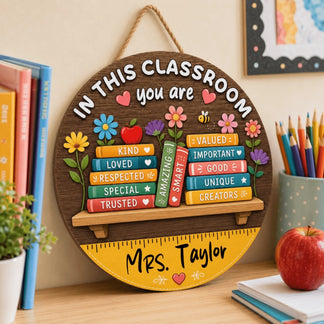Round wooden teacher sign personalized with name Mrs Taylor and colorful book illustrations for classroom wall decoration