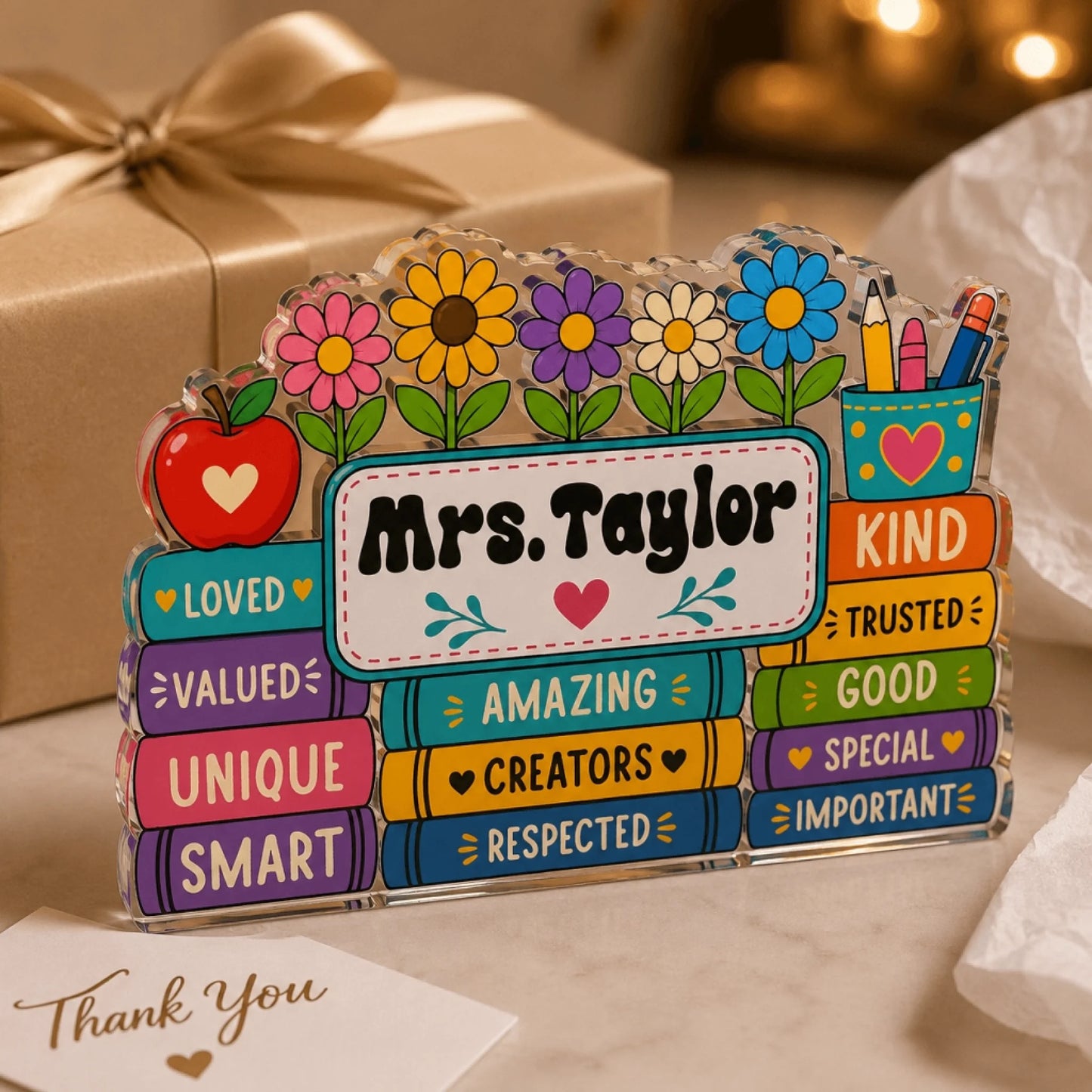 Mrs. Taylor custom acrylic teacher gift set on a desk, next to a wrapped gift and thank you note.