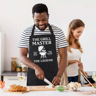 Man wearing a grill master apron while preparing vegetables, featuring a funny grill theme design for cooking lovers.