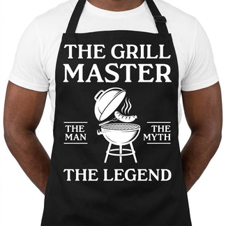 Close up of a black grill master apron with a white graphic of a grill and the text The Man The Myth The Legend.