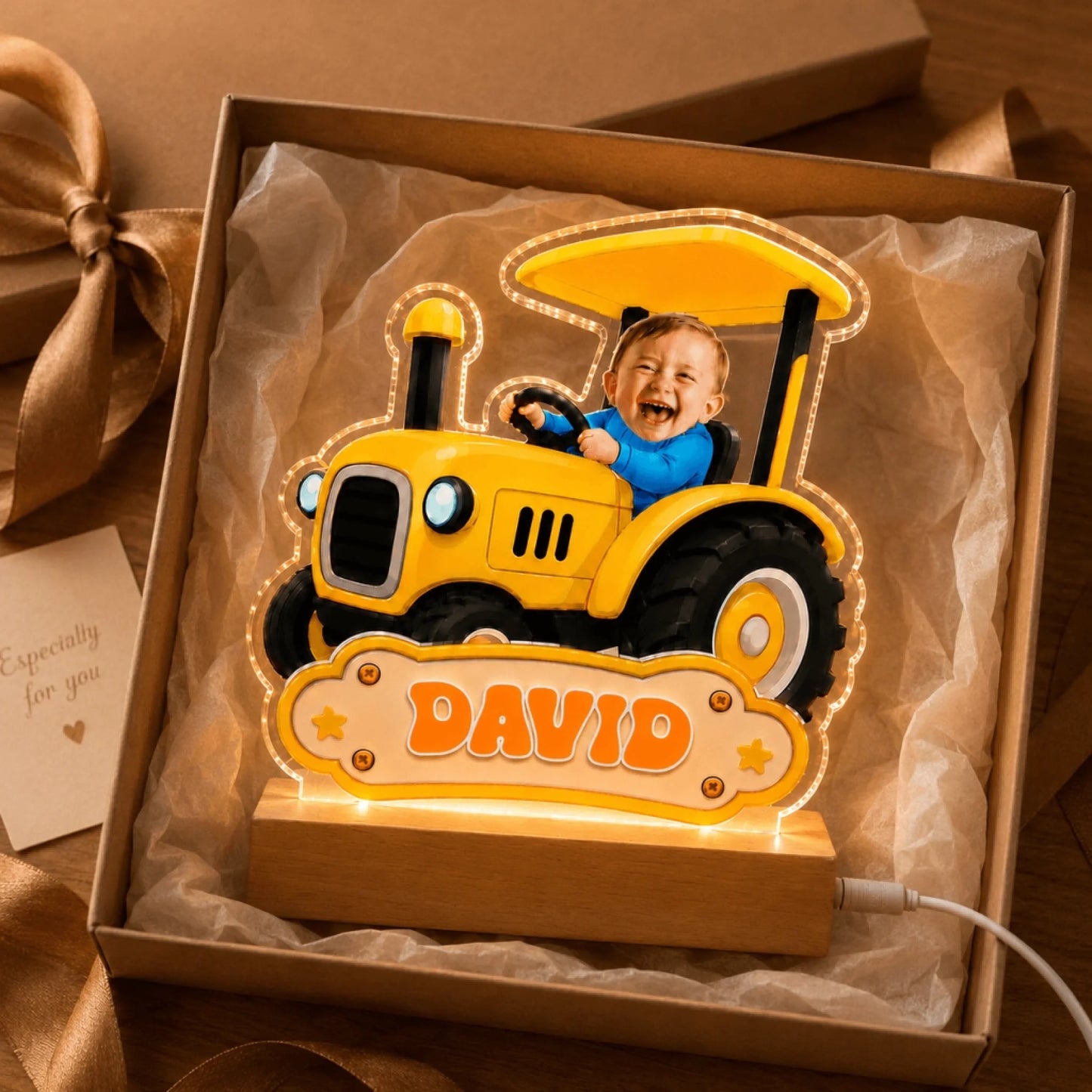 Personalized yellow tractor photo night light for child named David, displayed inside a gift box.