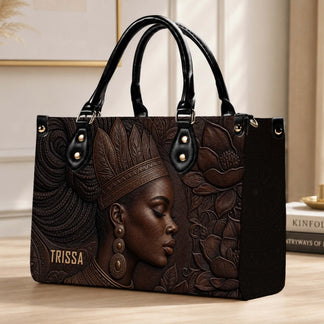 This premium PU leather handbag showcases an embossed portrait design and includes sturdy handles for daily use.