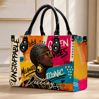 A stylish urban tote bag featuring a bold colorful illustration of an iconic woman with short hair and gold jewelry.