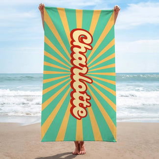 Vertical design personalized Charlotte beach towel featuring a 70s style sunburst pattern for beach lovers.