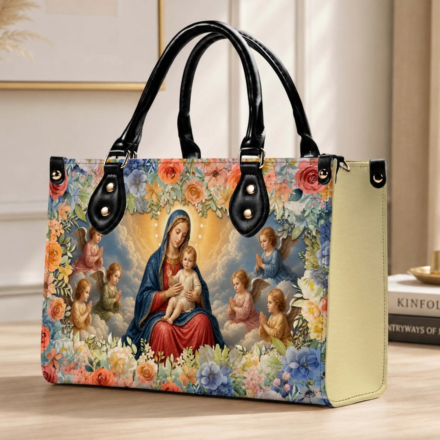 A beautiful PU leather handbag featuring the Virgin Mary and baby Jesus with angels surrounded by colorful flowers.
