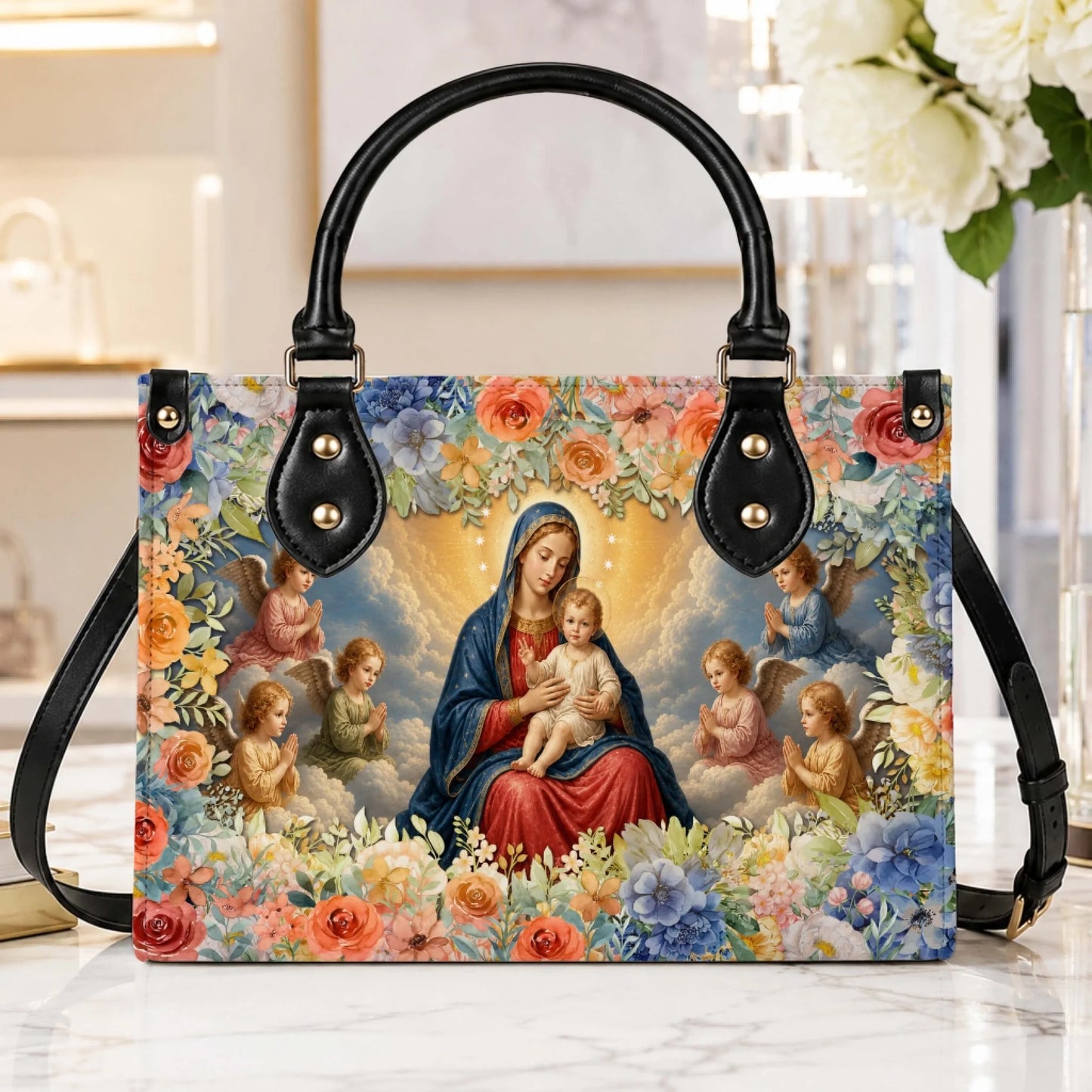 Religious themed handbag featuring a depiction of the Virgin Mary and child with angels, framed by a vibrant floral wreath.