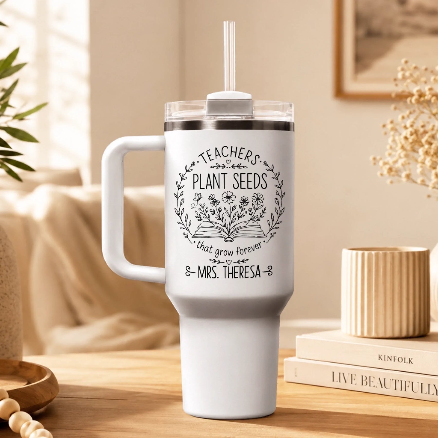 White personalized teacher tumbler featuring Teachers Plant Seeds design displayed on a wooden desk for teachers.