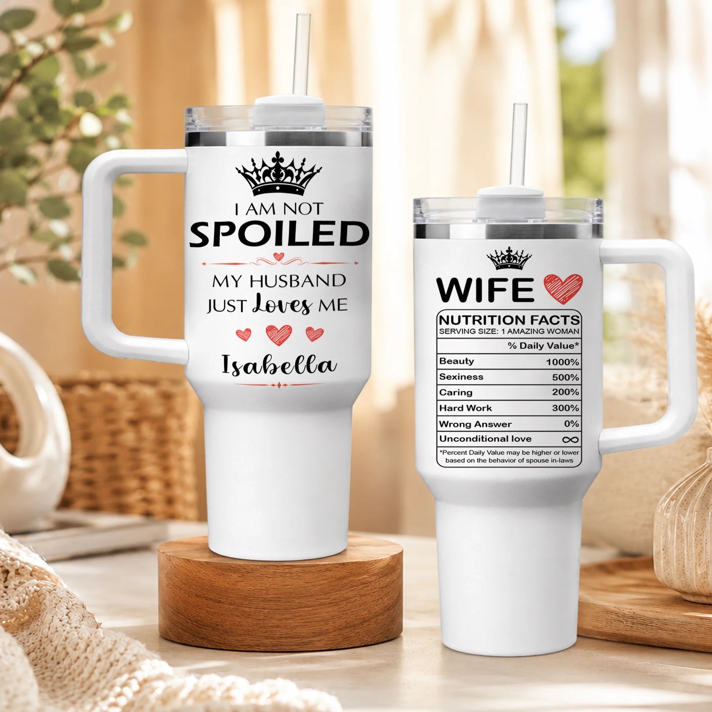 A set of white travel tumblers featuring the I am not spoiled quote and personalized nutrition facts label.