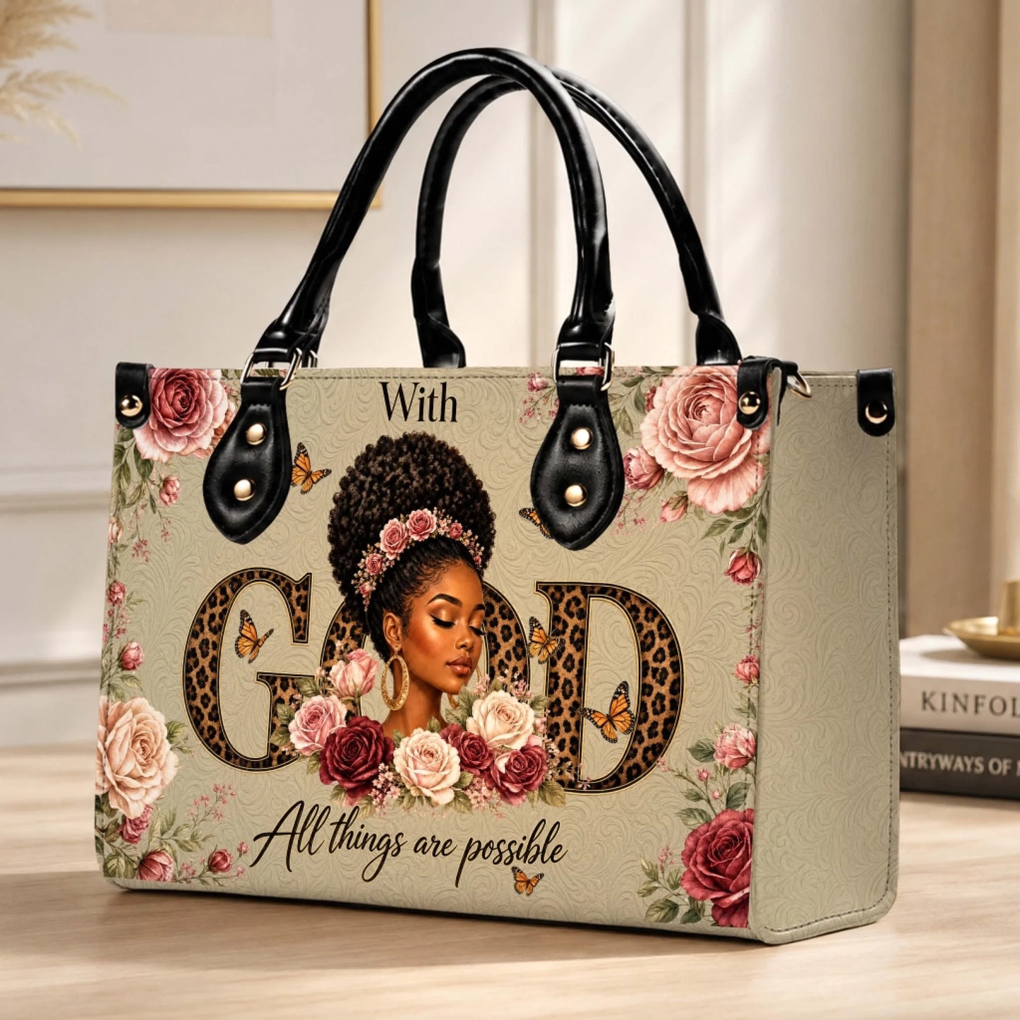 Beige tote bag with black handles, artistic illustration of a black woman, roses, butterflies, and faith-based quote.