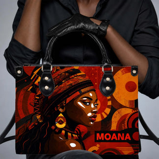 A fashion-forward PU leather handbag showcasing African-inspired art, carried by a woman wearing black gloves.