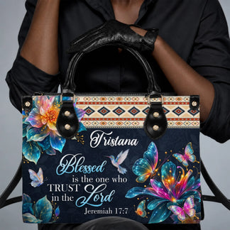 Person holding a custom handbag with butterfly and hummingbird design featuring religious quote and name Tristana