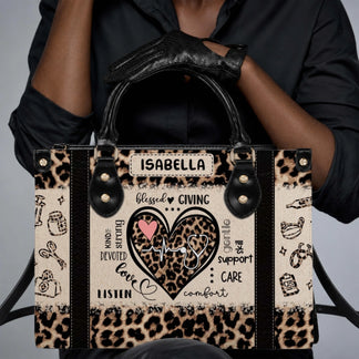 Close up of a person holding a custom leopard print nurse tote bag with stethoscope heartbeat motif and Isabella name personalization.